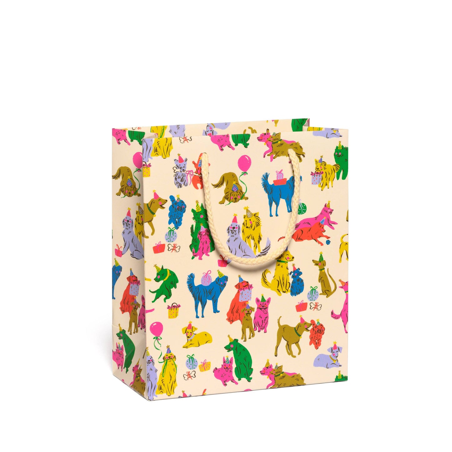 A square gift bag with cream-colored handles, covered in a colorful repeating pattern of whimsical cartoon cats wearing party hats and small balloons, on a solid white background.