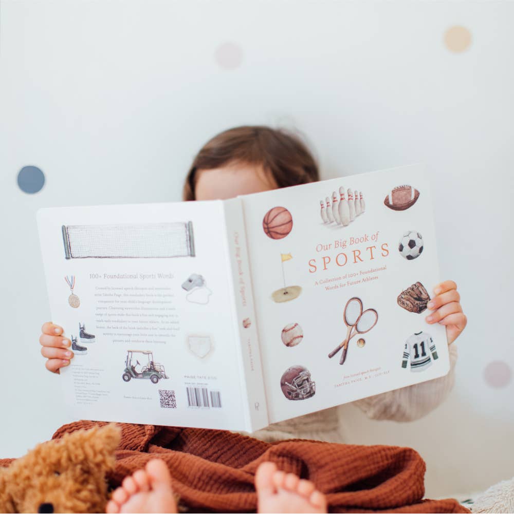 Child reading a book titled 'Big Book of Sports' with illustrations on a light background
