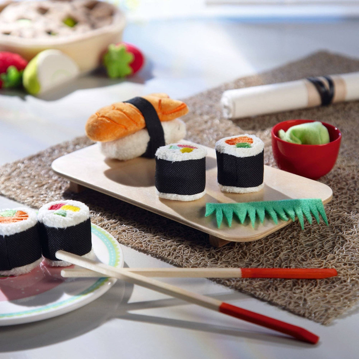 Toy sushi set with chopsticks on a table