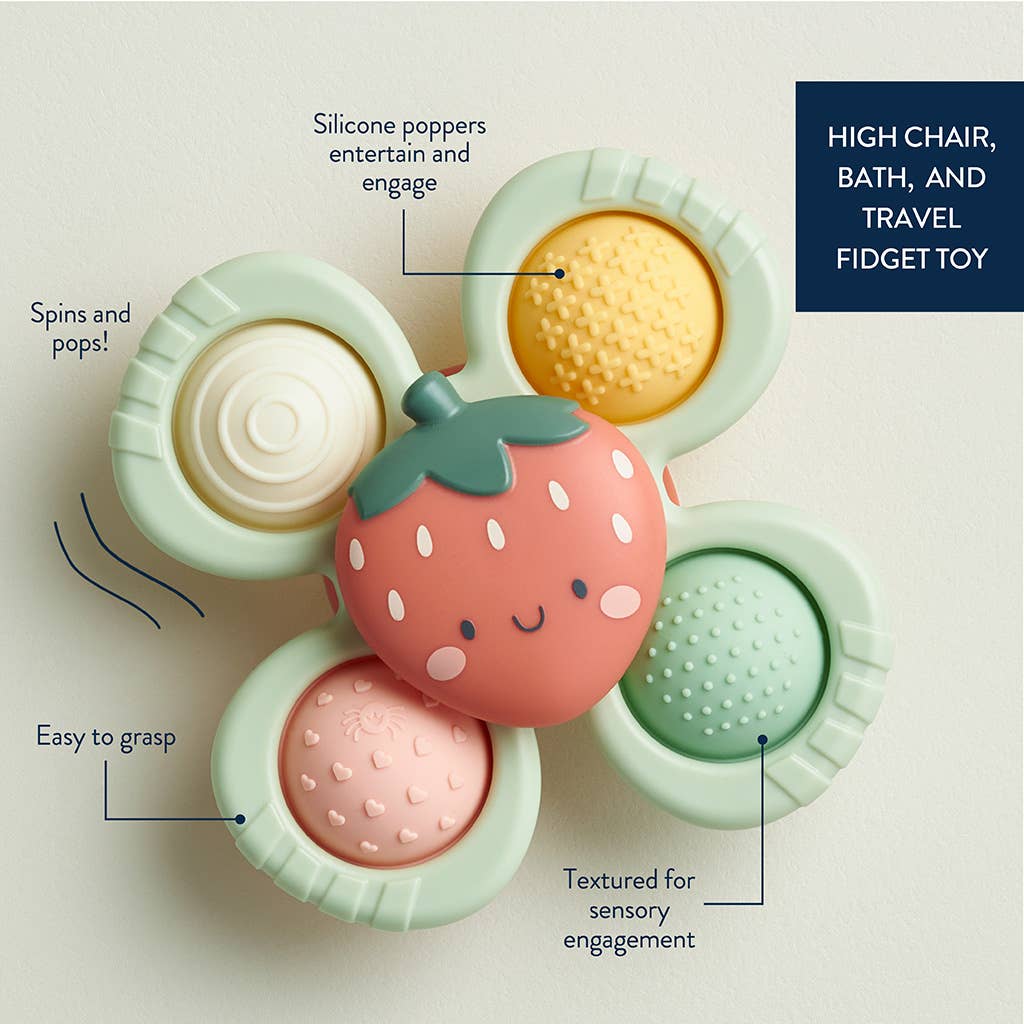 A baby fidget spinner with a suction cup base and multiple colorful silicone sensory poppers, designed to look like a strawberry on a light background with text pointing out features for highchair, bath and travel