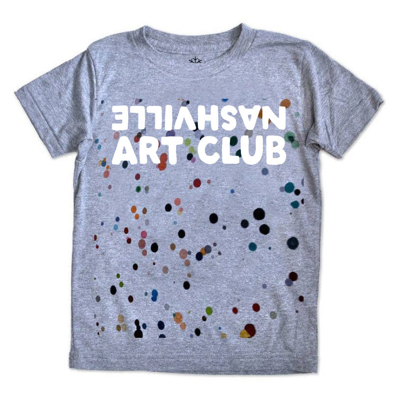 Gray Tshirt with colored paint splatters with the words Nashville Art Club printed in white. Nashville is both upside down and backward.