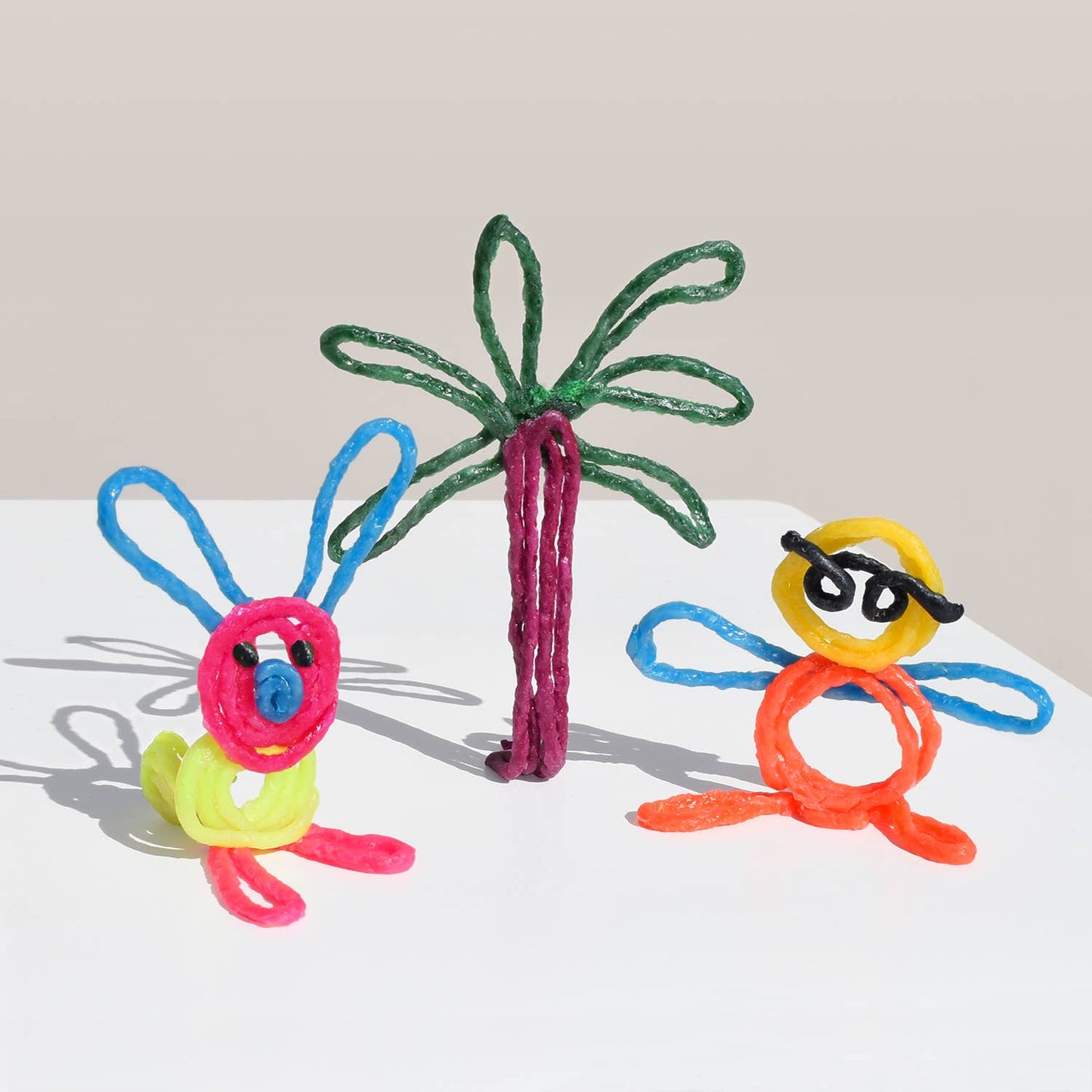 Colorful wikki stix creations on a white background