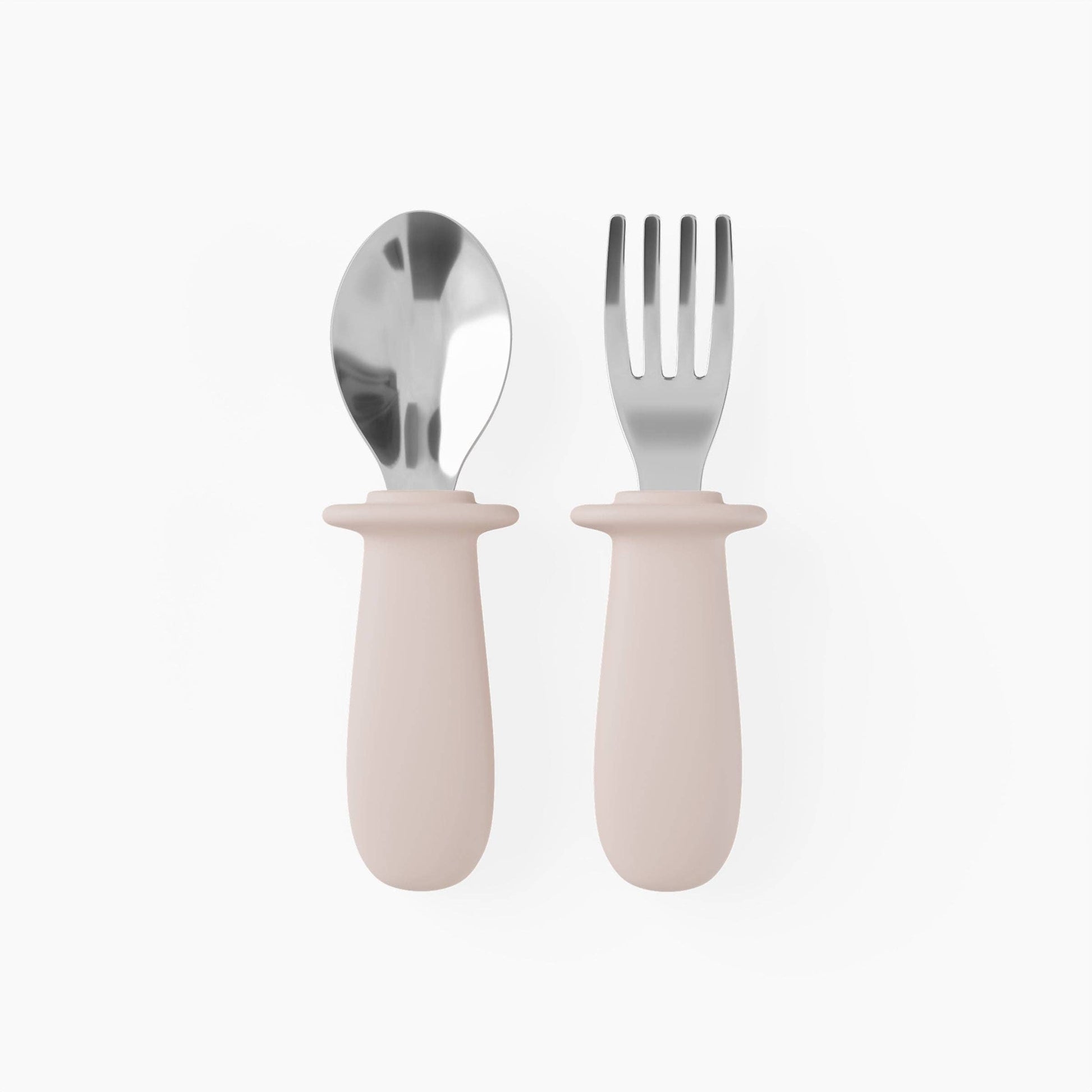 Set of silver spoon and fork with pink silicone handles on a white background