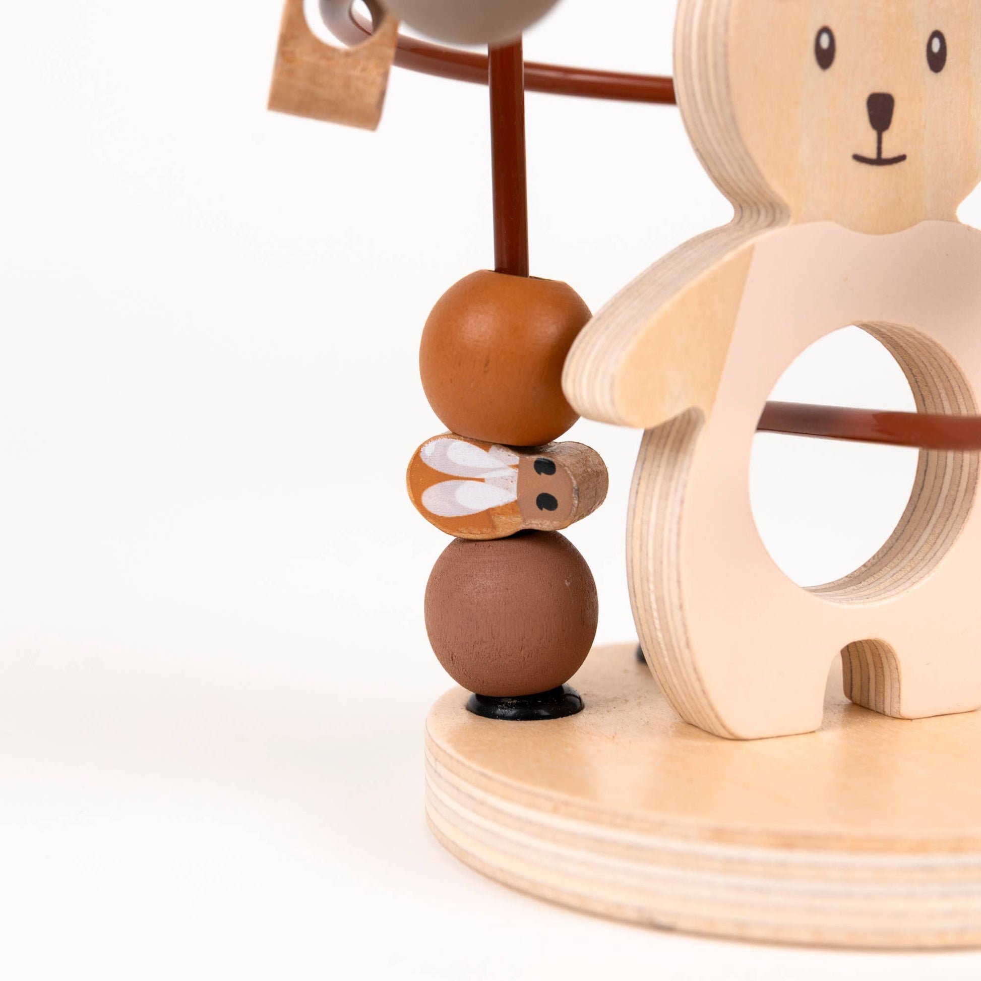 Wooden baby toy with bear design and brown beads on a white background