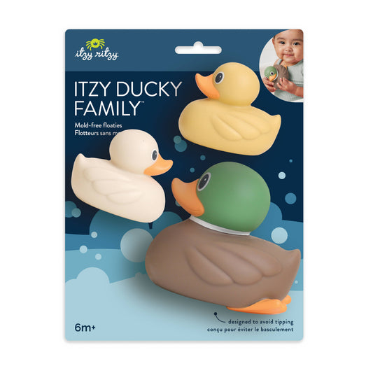 Itzy Ducky Family mold-free floats set in its retail packaging, featuring three rubber duck toys: a yellow one, a cream/off-white one, and a duck-shaped one with a green head, brown body, and orange beak.