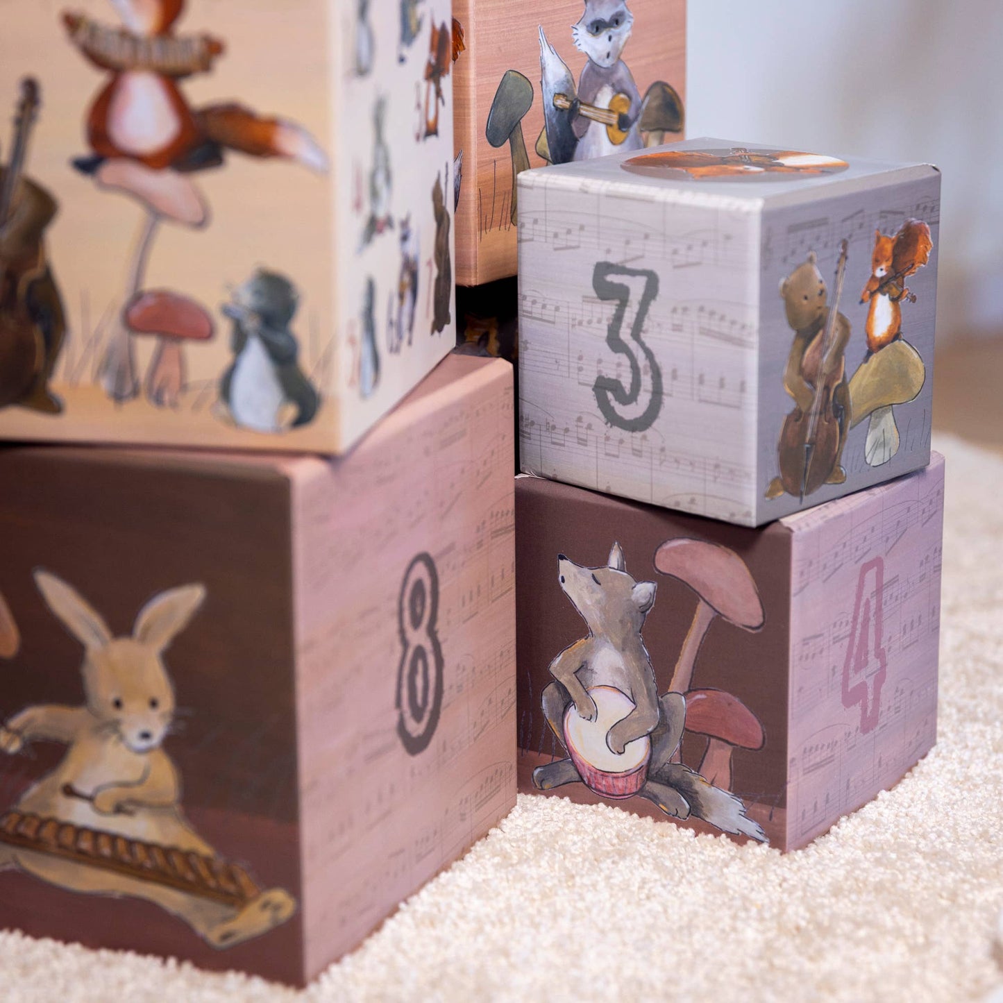coated paper blocks with animal illustrations and numbers on a soft surface