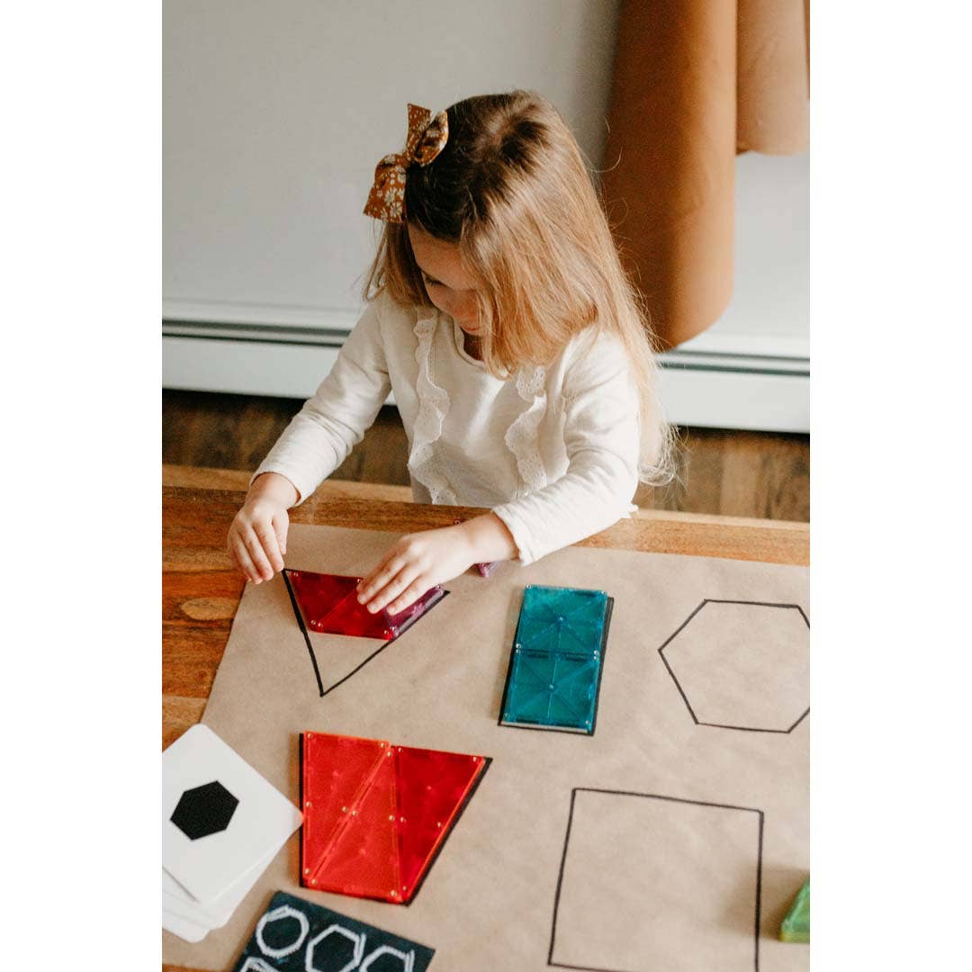 Child playing with geometric shapes on a table