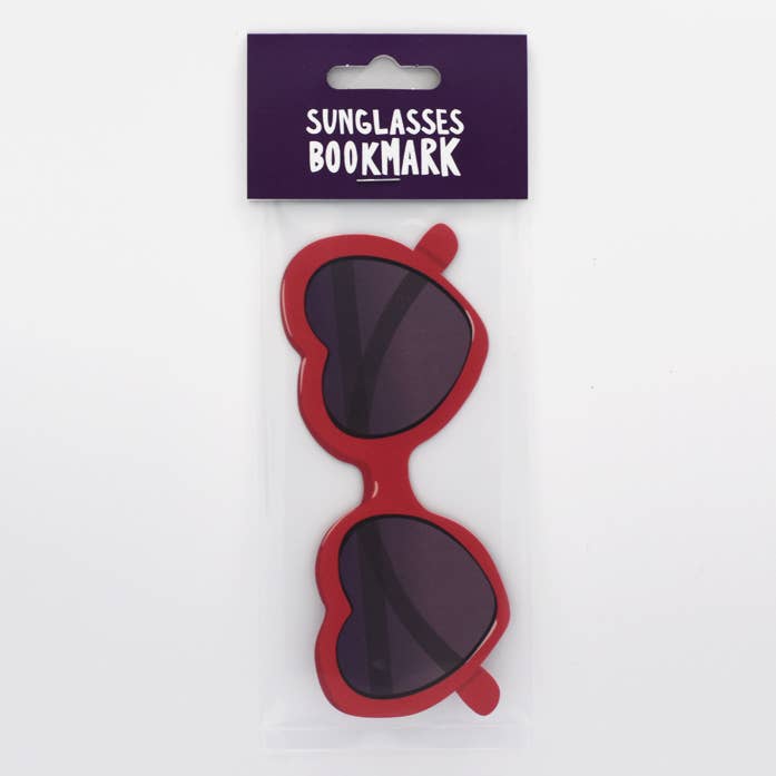 Red sunglasses shaped like eyeglasses with a purple packaging label on a white background