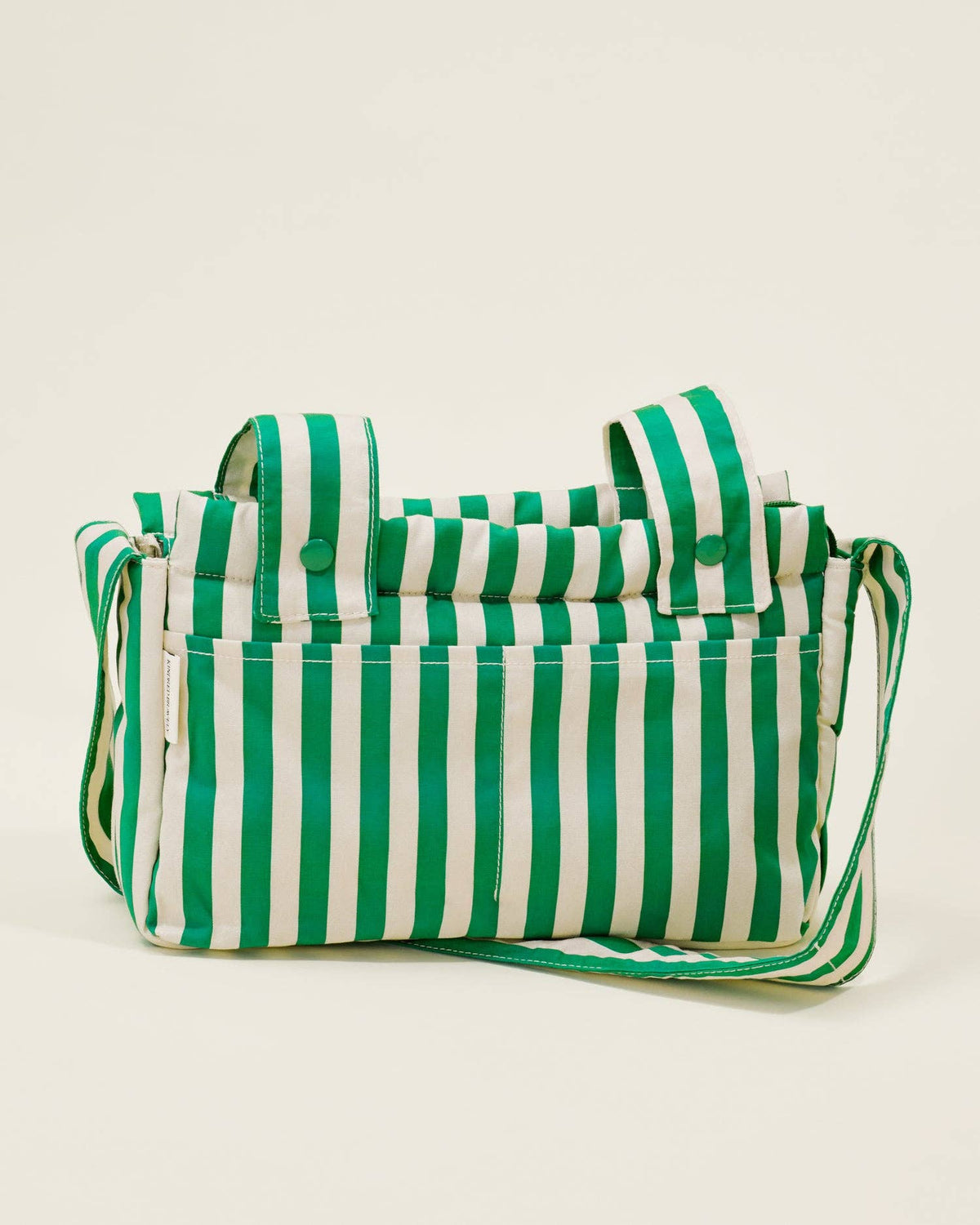 Green and white striped bag on a beige background