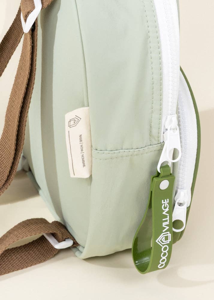Green bag with a visible brand tag on a light background