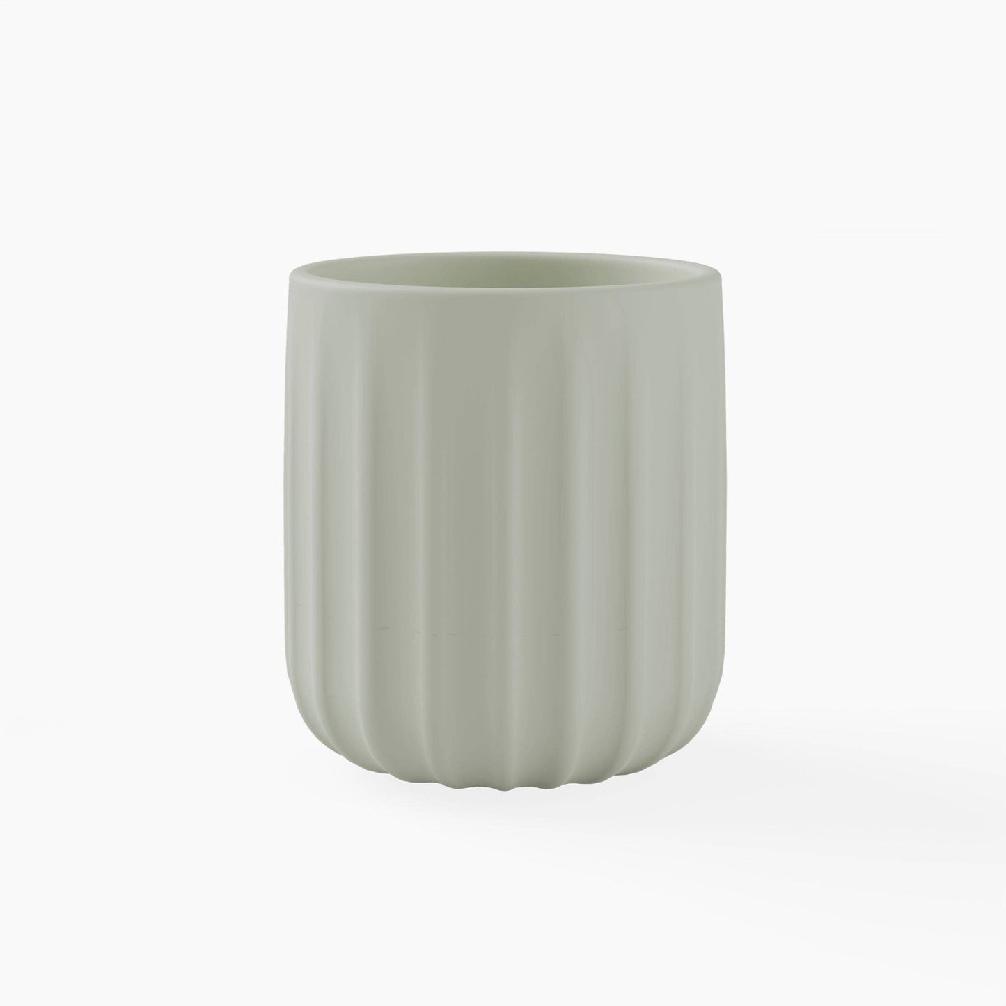 Green silicone cup with textured surface on a white background
