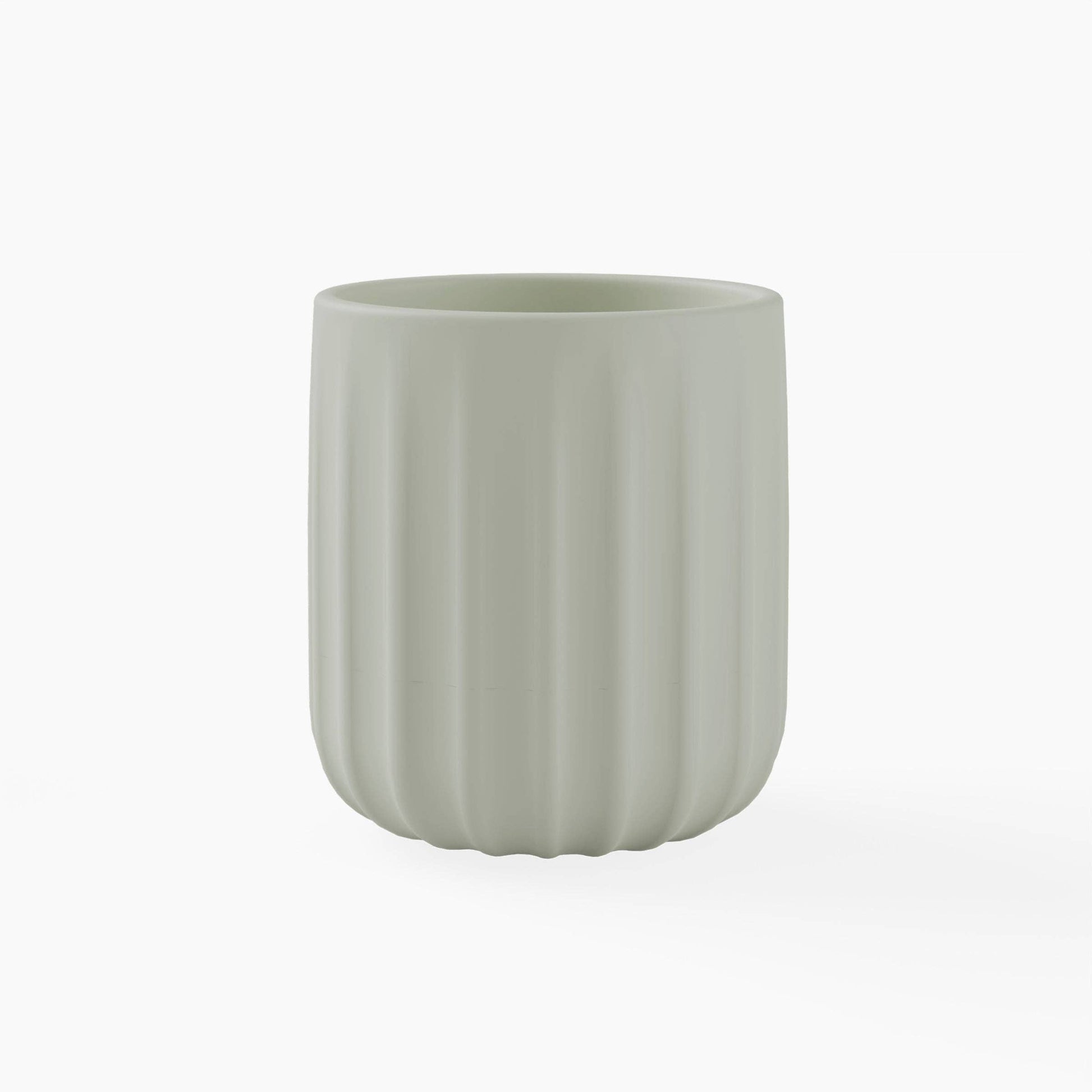 Green silicone cup with textured surface on a white background