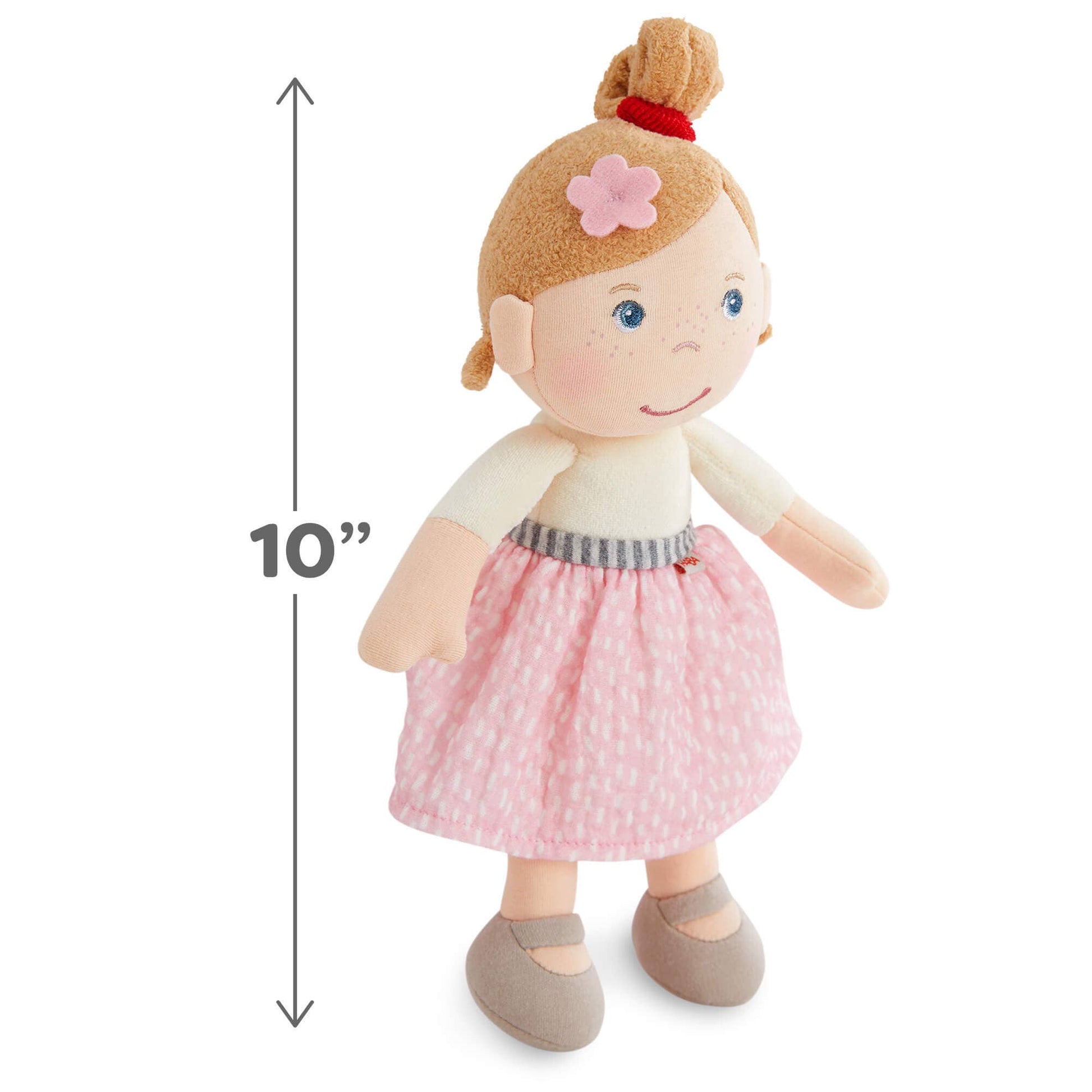 Stuffed doll with a pink skirt and measurement label on a white background