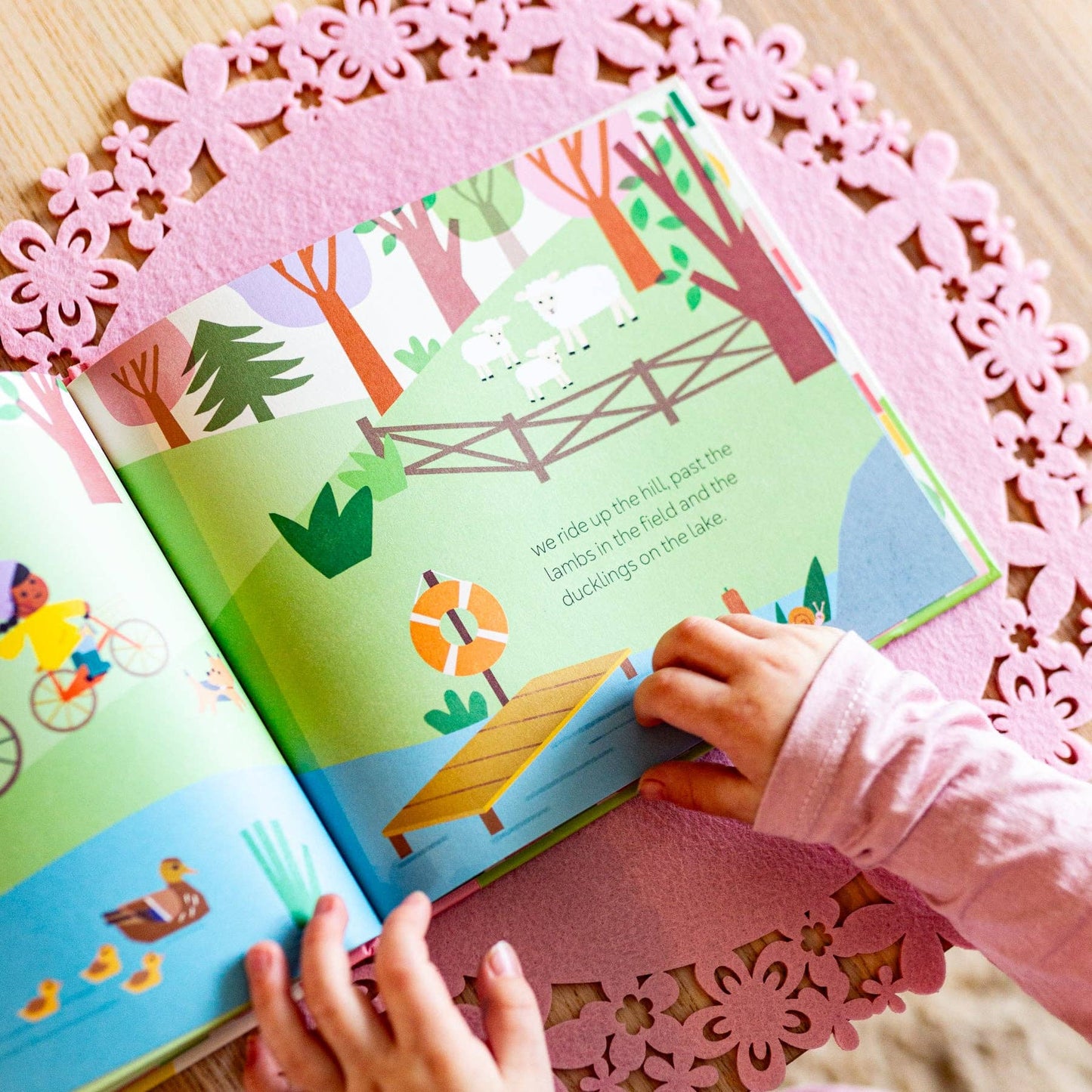 Children's book with colorful illustrations on a pink doily