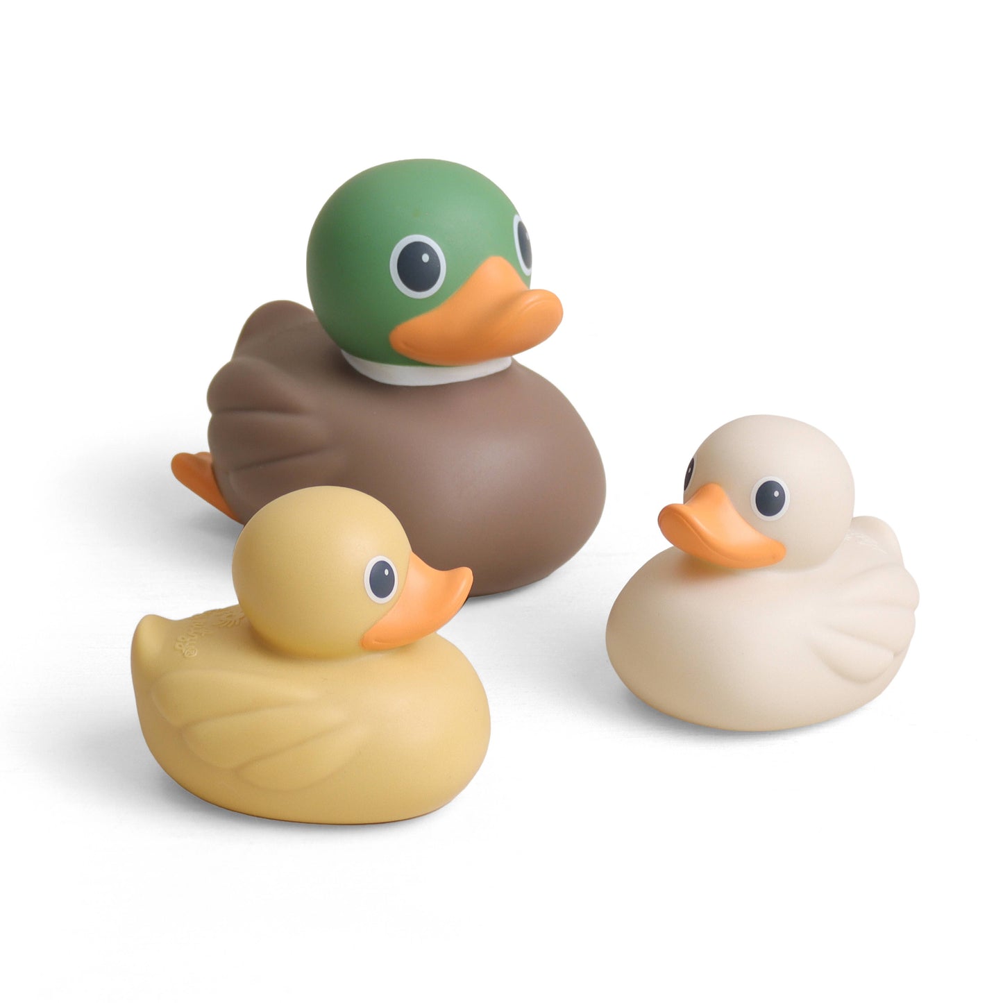 Three duck-shaped bath toys on a clean white background: one green-headed mallard, one tan duck, and one cream-colored duck, all with orange beaks.