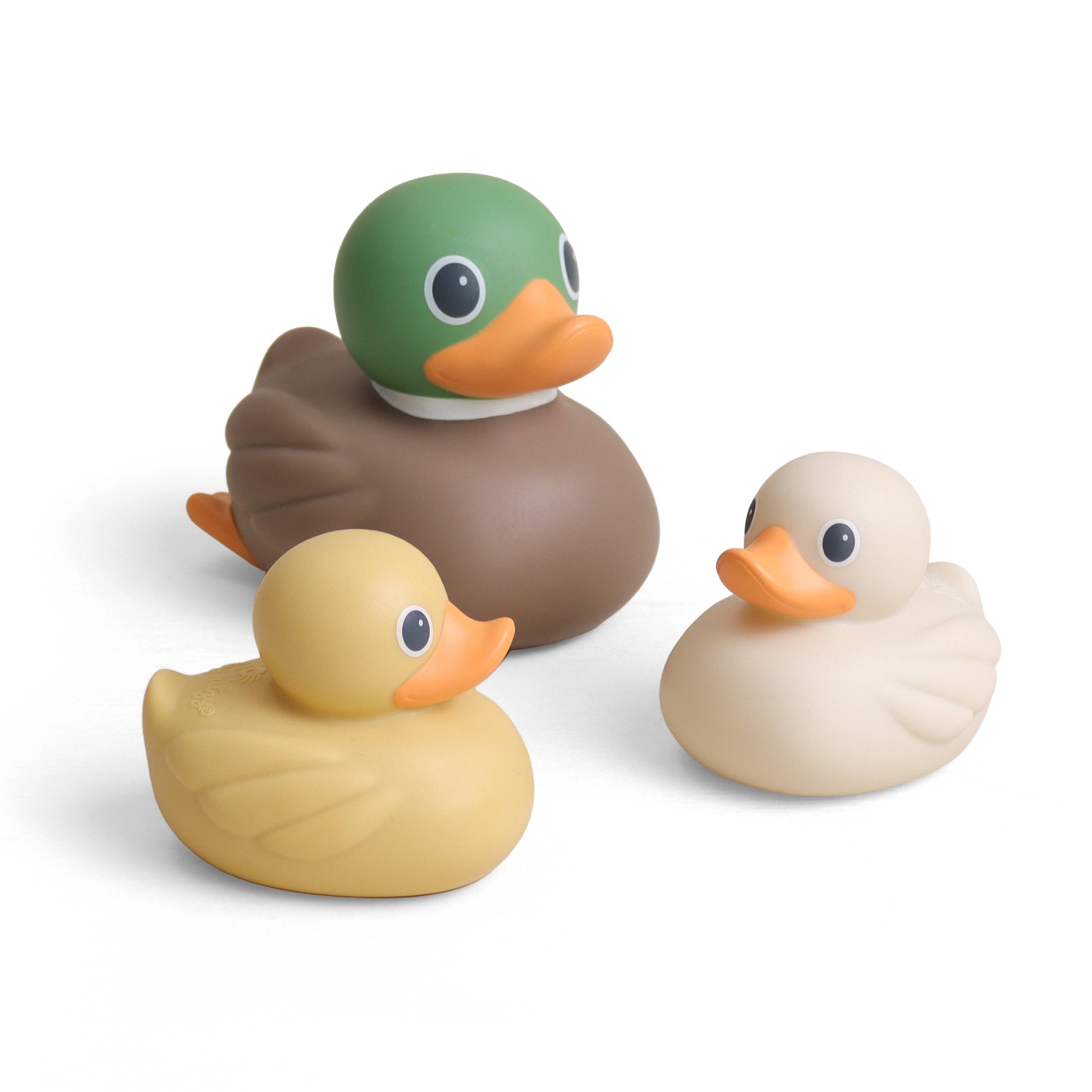 Three duck-shaped bath toys on a clean white background: one green-headed mallard, one tan duck, and one cream-colored duck, all with orange beaks.