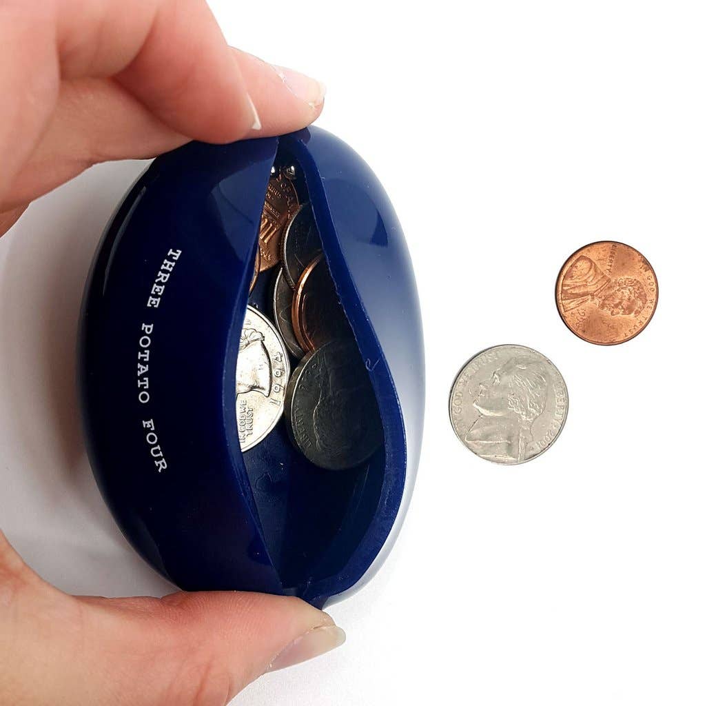 Blue coin holder with coins and a hand holding it on a white background