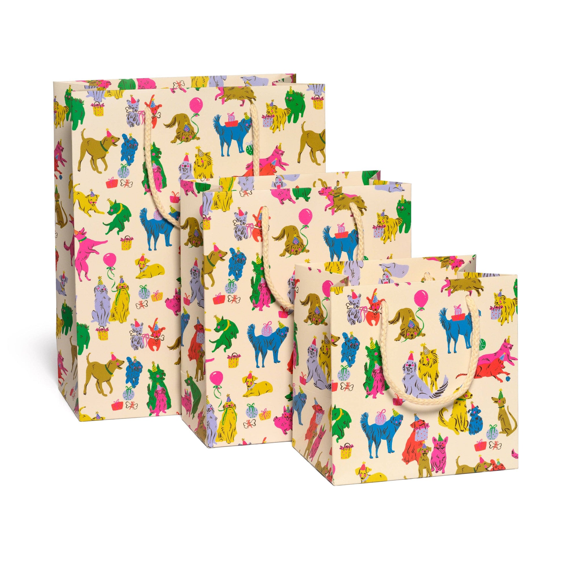 Set of three colorful gift bags with animal patterns on a white background