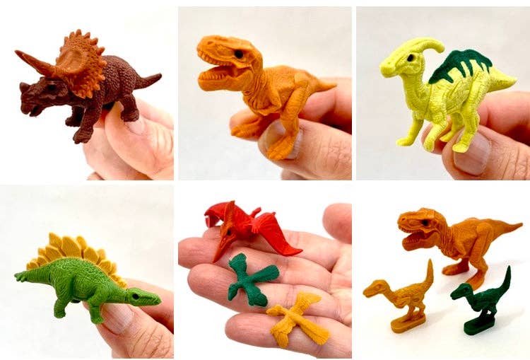 Set of small dinosaur figurines held in hands against a white background