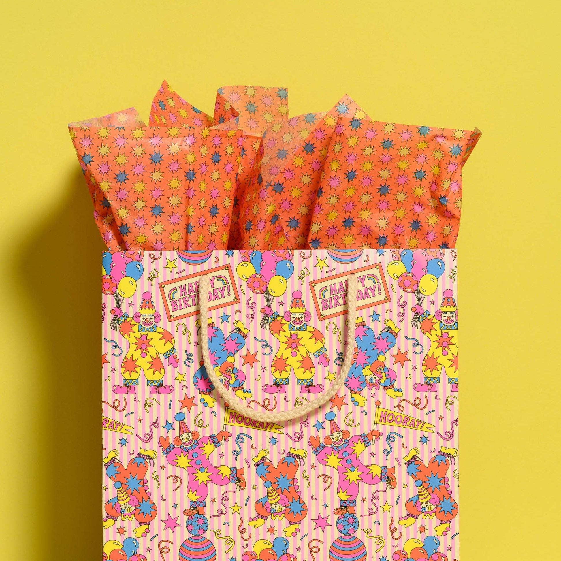 Colorful gift bag with clown design on a yellow background