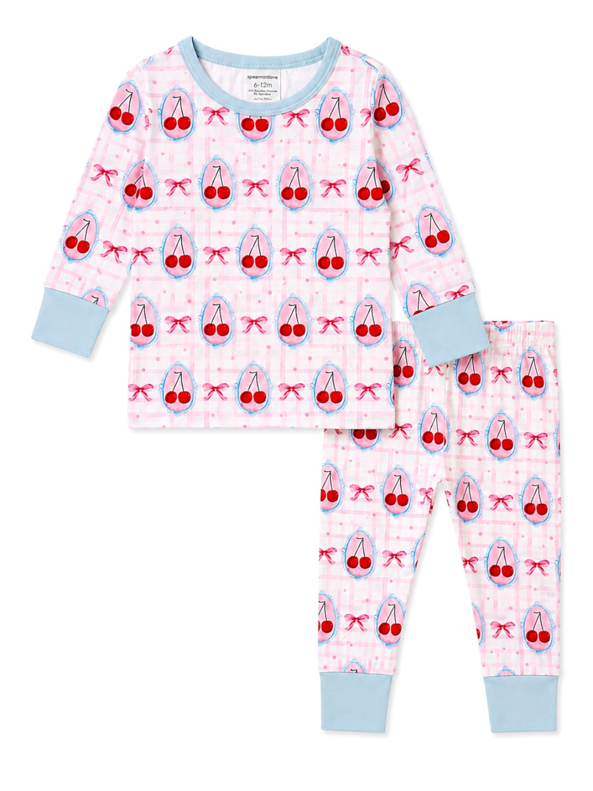 A two-piece children's pajama set featuring a long-sleeve top and matching pants. The pajamas have a light pink and white gingham pattern with an all-over print of red cherries in blue bows, light blue trim on the collar and cuffs, and light blue ankle cuffs.