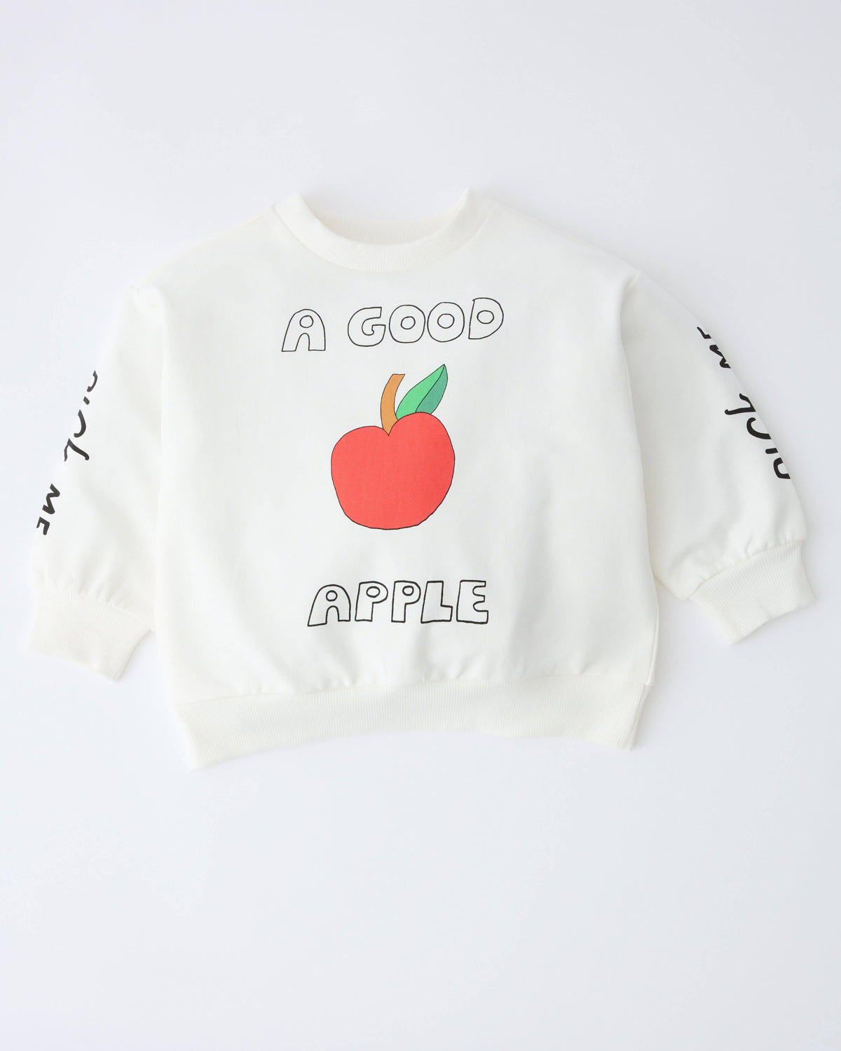 A white long-sleeve sweatshirt featuring a graphic of a red apple with green leaves and the words 'A GOOD APPLE' printed on the front, with black script text on both sleeves.