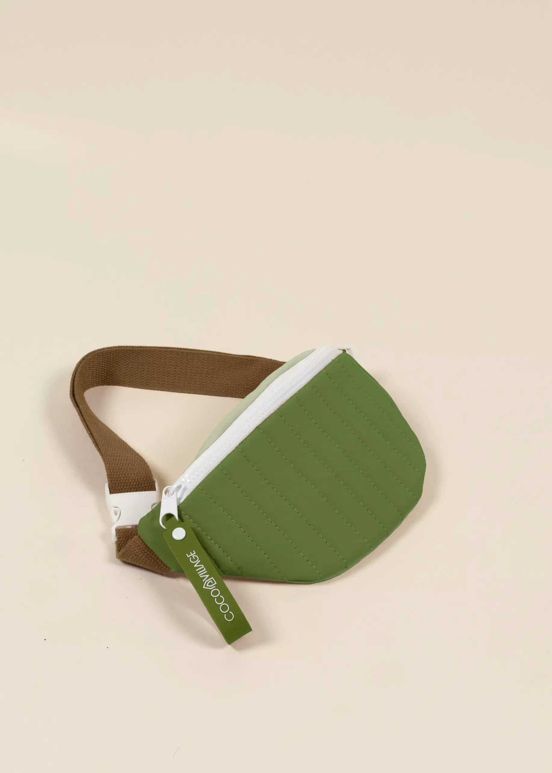 Green and brown waist bag on a beige background
