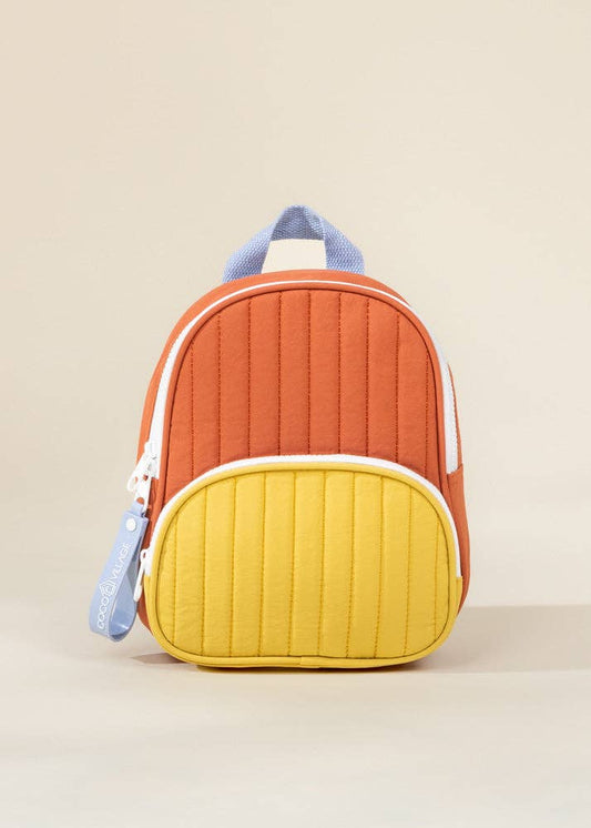 Colorful quilted backpack with orange top and yellow bottom on a beige background