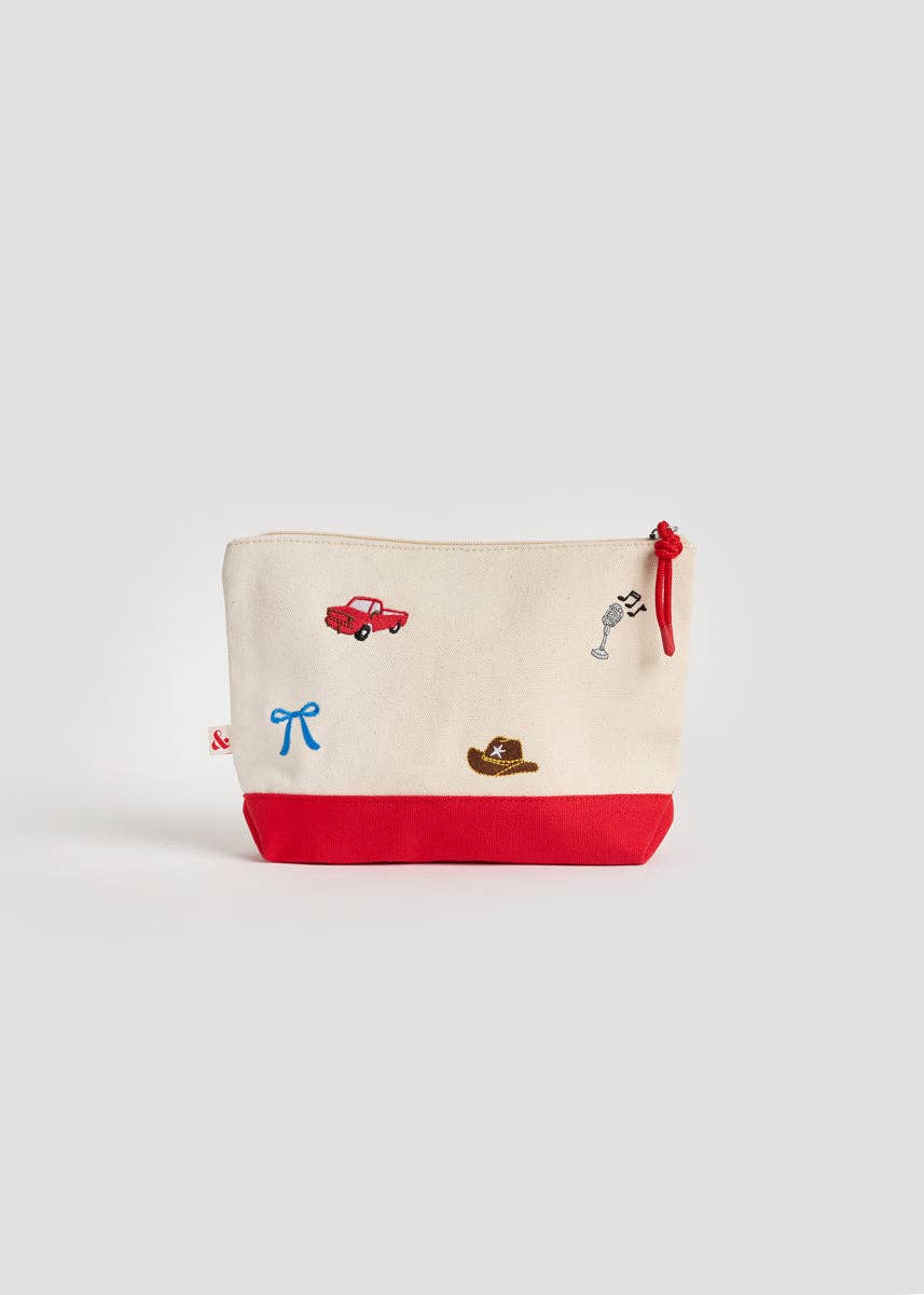 An off-white canvas zippered pouch with a solid red bottom base and small embroidered cartoon motifs including a red car, a blue bow, a cowboy hat, and a dalmatian.