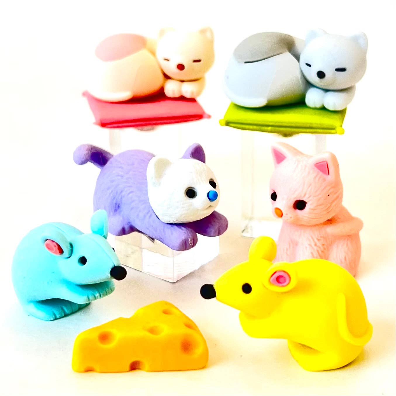 Colorful animal-shaped erasers on a white background