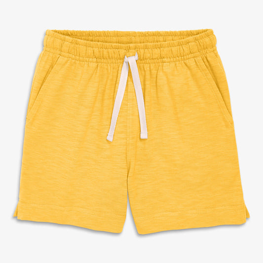 Yellow shorts with a drawstring on a light gray background
