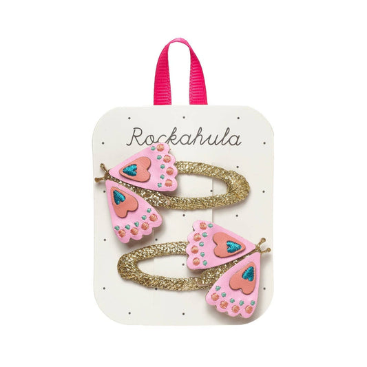 Pink butterfly-shaped hair clips on a Rockahula branded card.