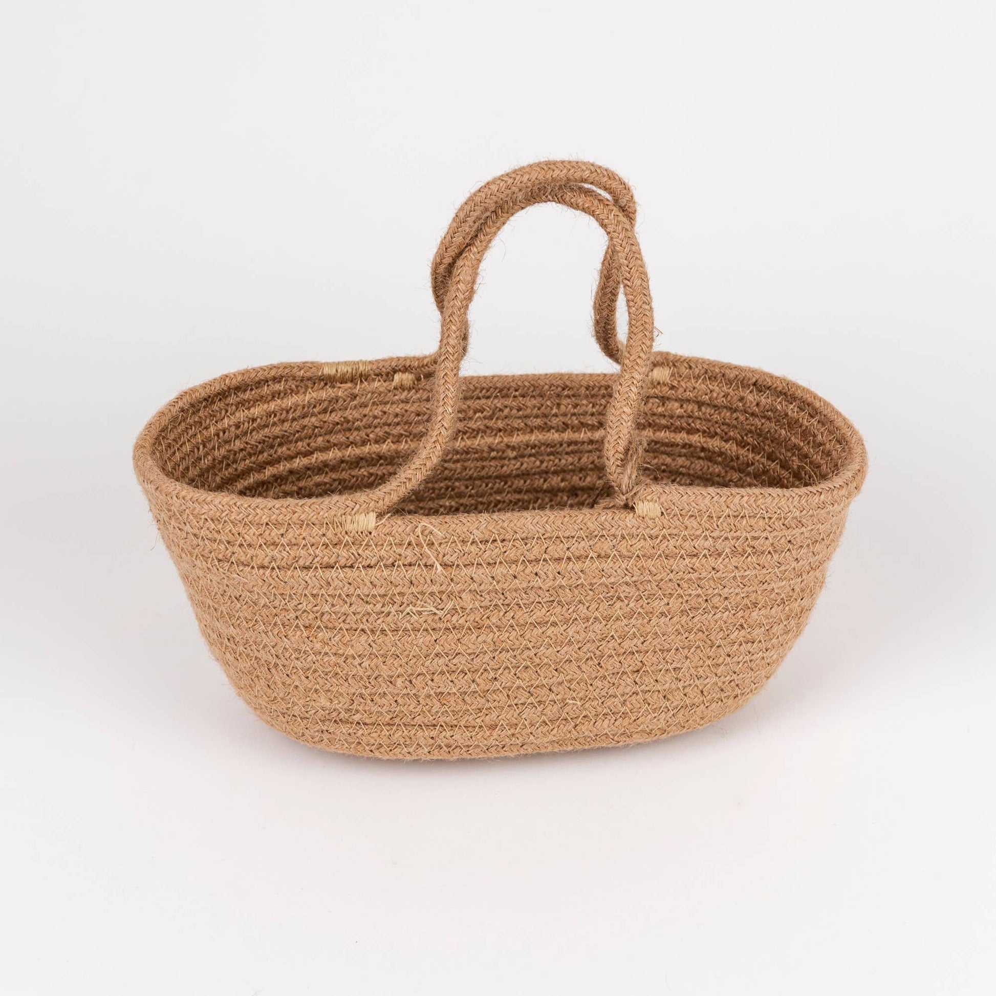 A small woven basket made from natural jute rope with two loop handles, shown on a clean white background.