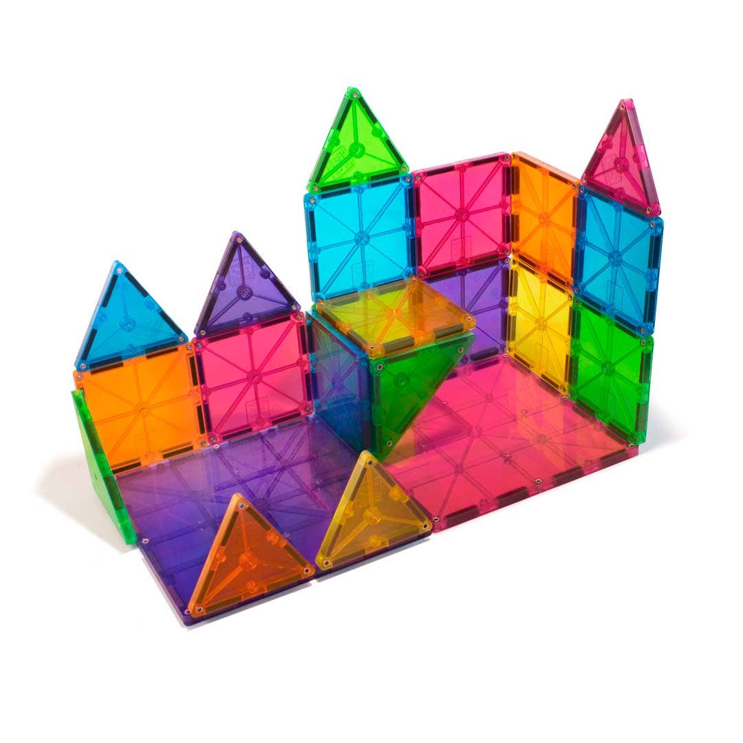 Colorful magnetic building blocks arranged to form a castle on a white background