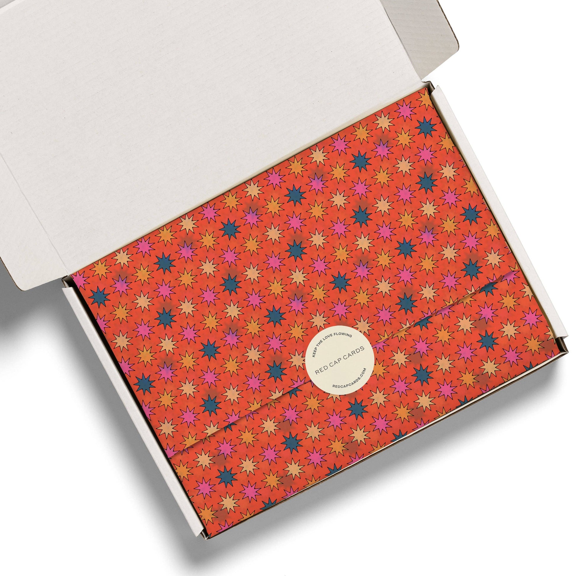 Product packaging with colorful star pattern and visible brand logo on a white background