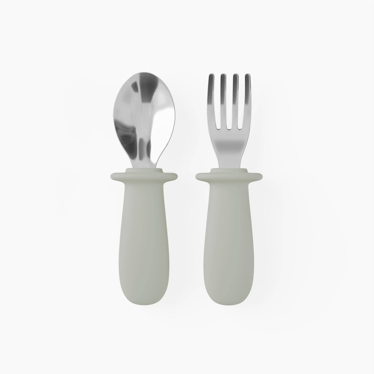 Silver spoon and fork with white handles on a white background