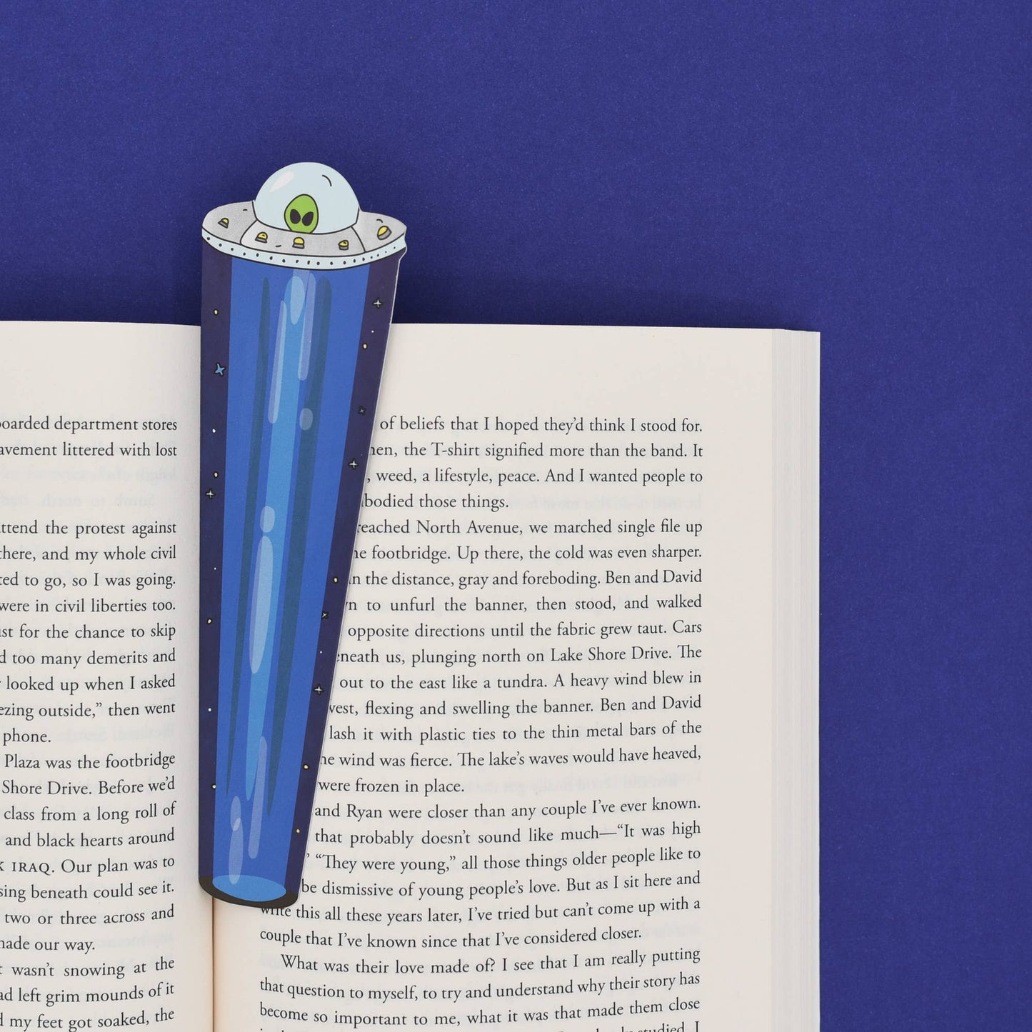 UFO-shaped blue bookmark on an open book with a blue background