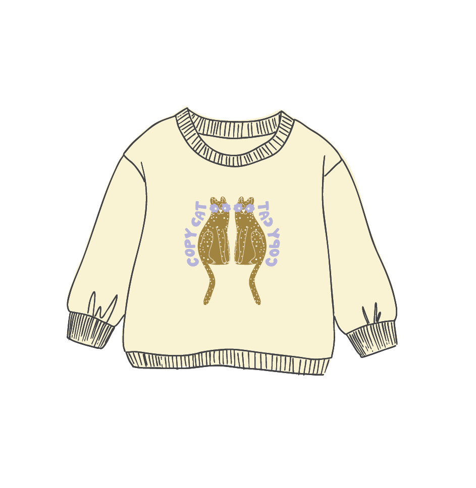A cream-colored long-sleeve sweater with a graphic of two gold glittery frogs facing each other, with purple text reading 'copy cat' around them, shown on a plain white background.