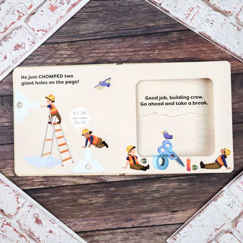Children's book page with illustrations of construction workers and a bird on a wooden surface.