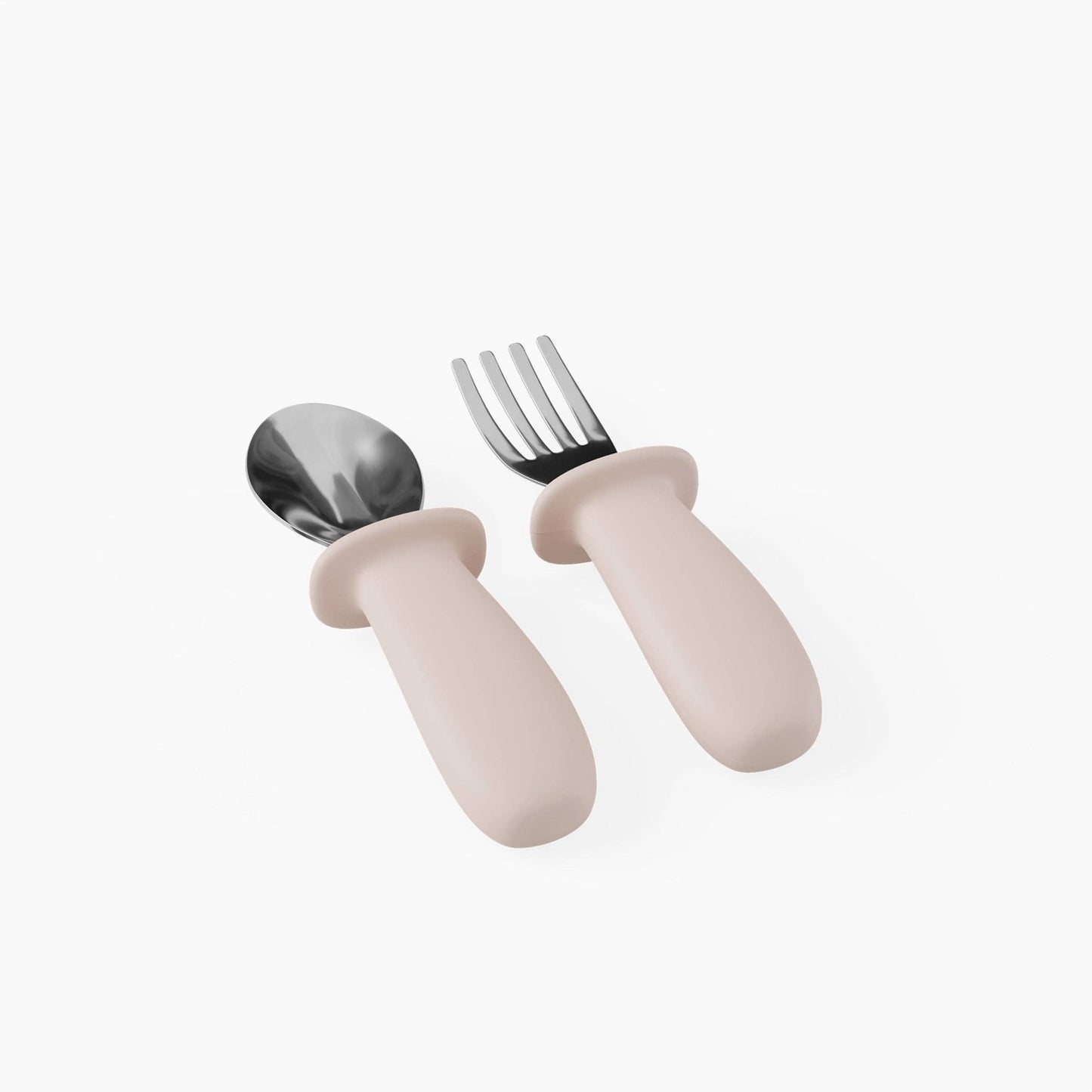 Set of children's cutlery with pink handles on a white background