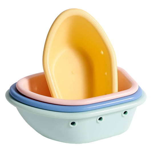 Three pastel-colored plastic baby bath tubs nested inside one another, with a yellow tub standing upright inside the stack on a plain white background.