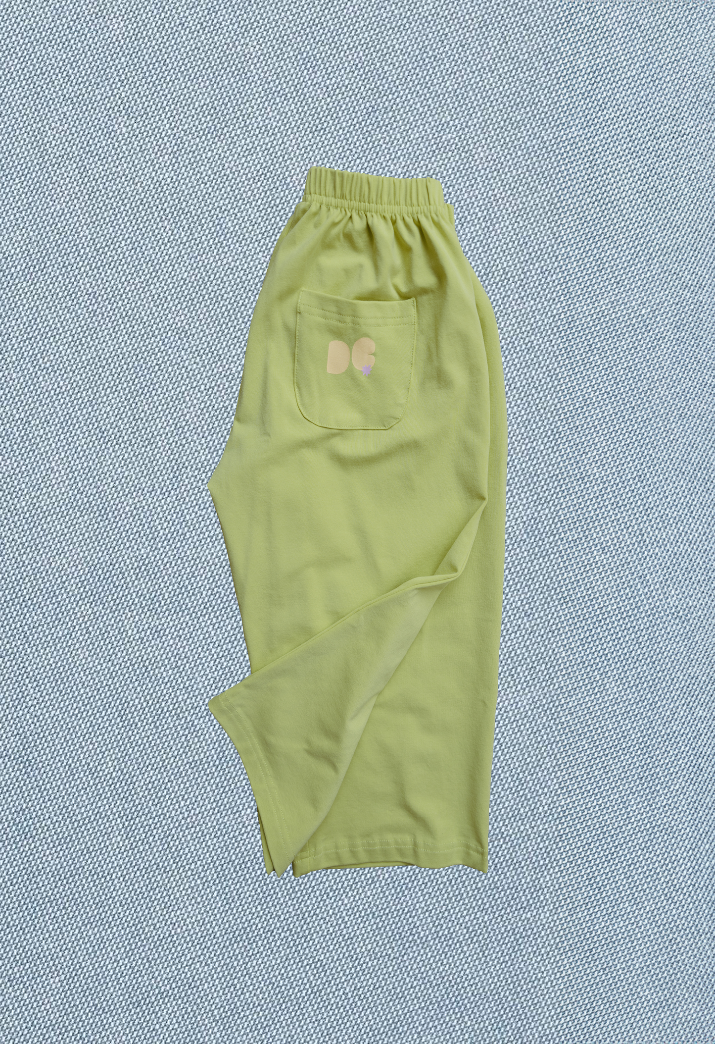 Green pants with a pocket on a textured blue background