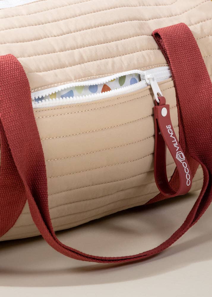 Red and beige duffel bag with zipper