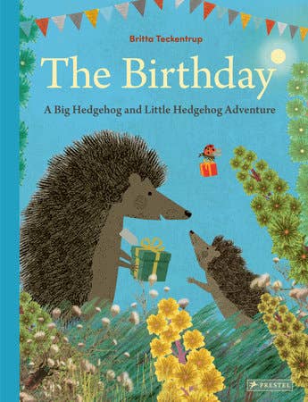 Book cover of 'The Birthday' featuring hedgehogs and a blue background with flowers and flags.