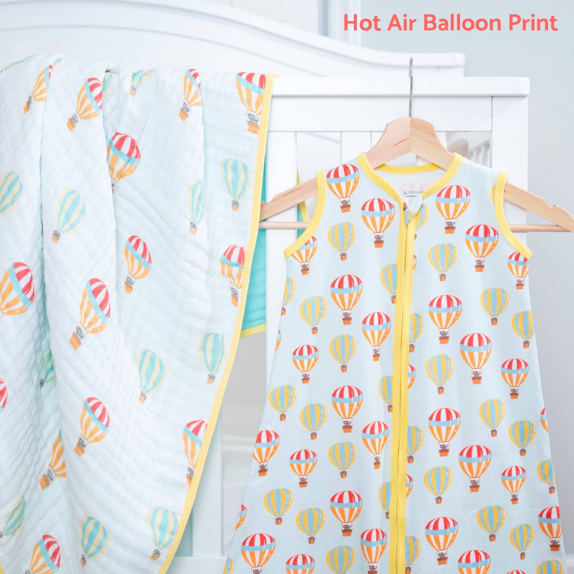 Baby sleeping sack with hot air balloon pattern on a hanger against a white background