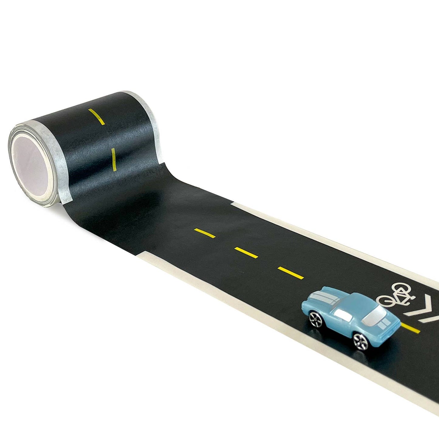 Roll of road tape with a toy car on a white background
