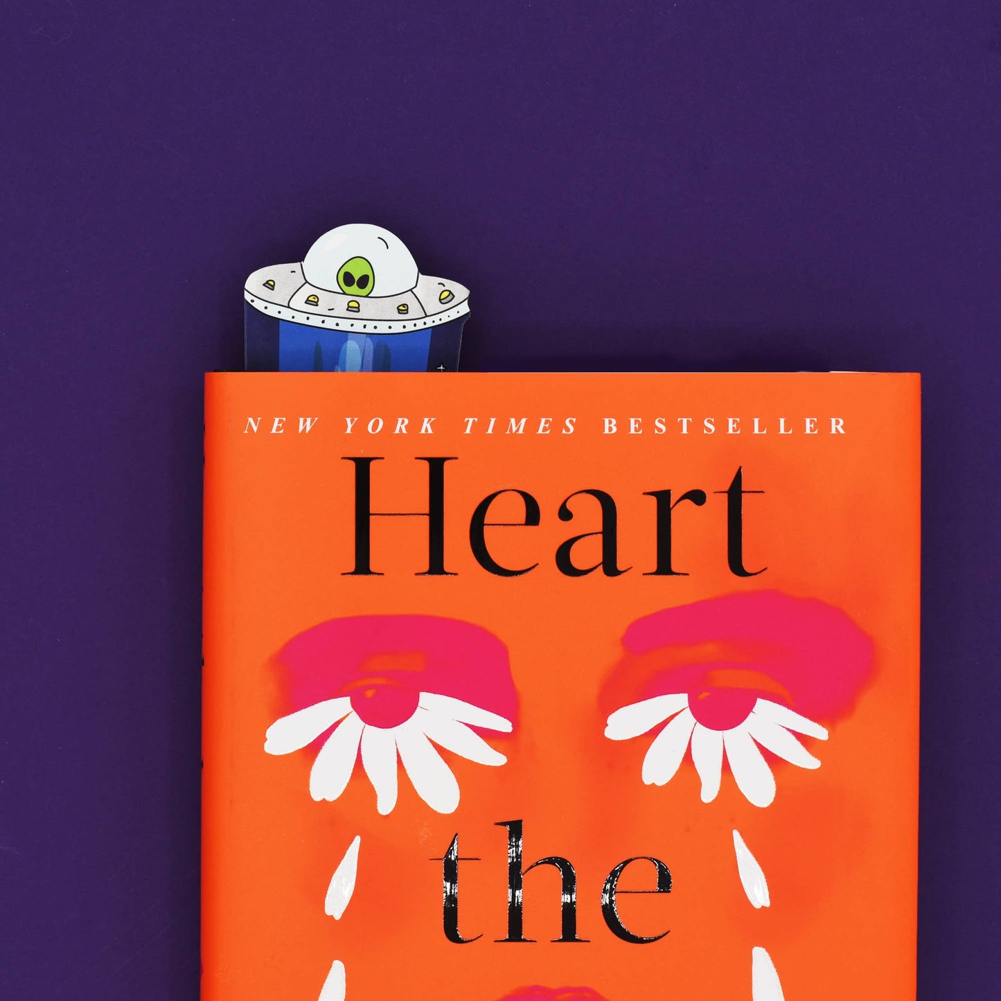 Book titled 'Heart the' by New York Times Bestseller on an orange cover with a purple background