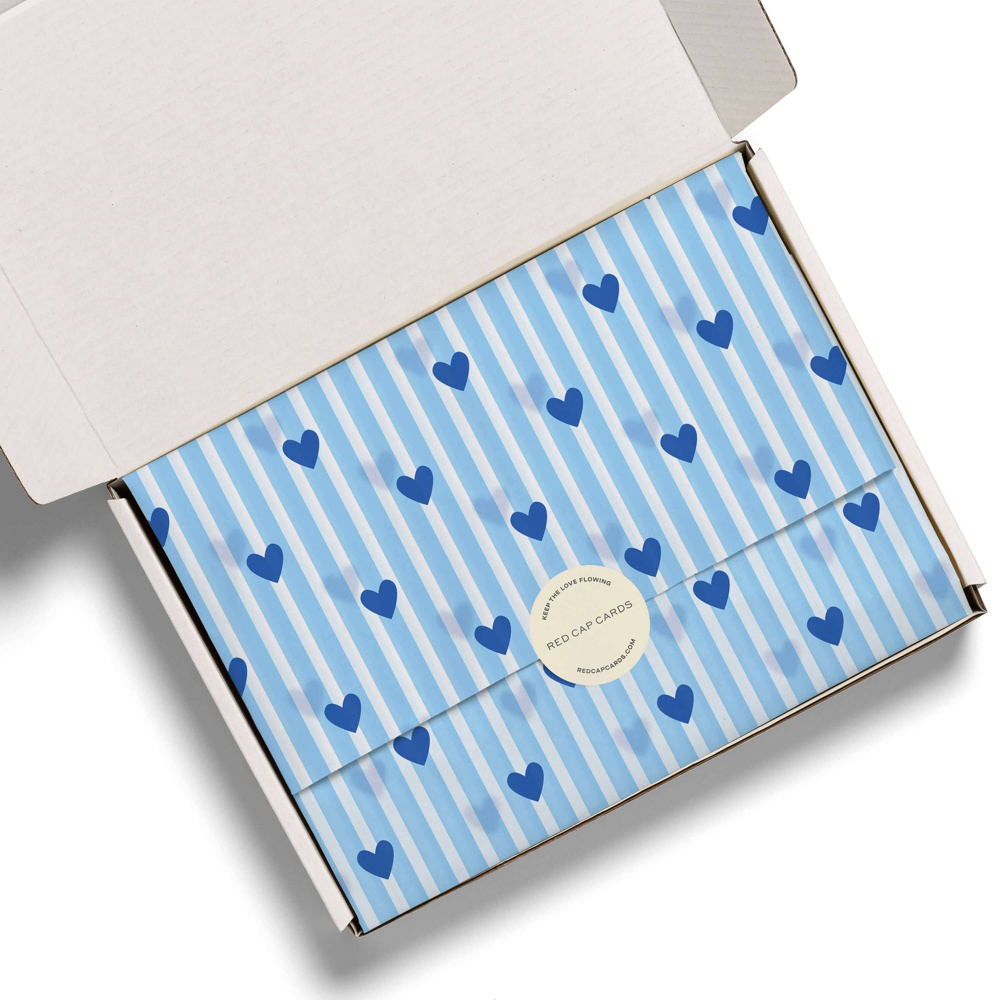 Gift box with blue heart pattern on a white background