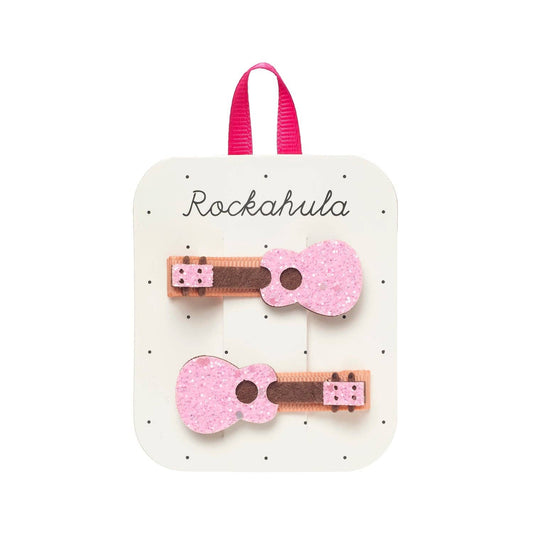 Pink guitar-shaped hair clips on a 'Rockahula' branded card.