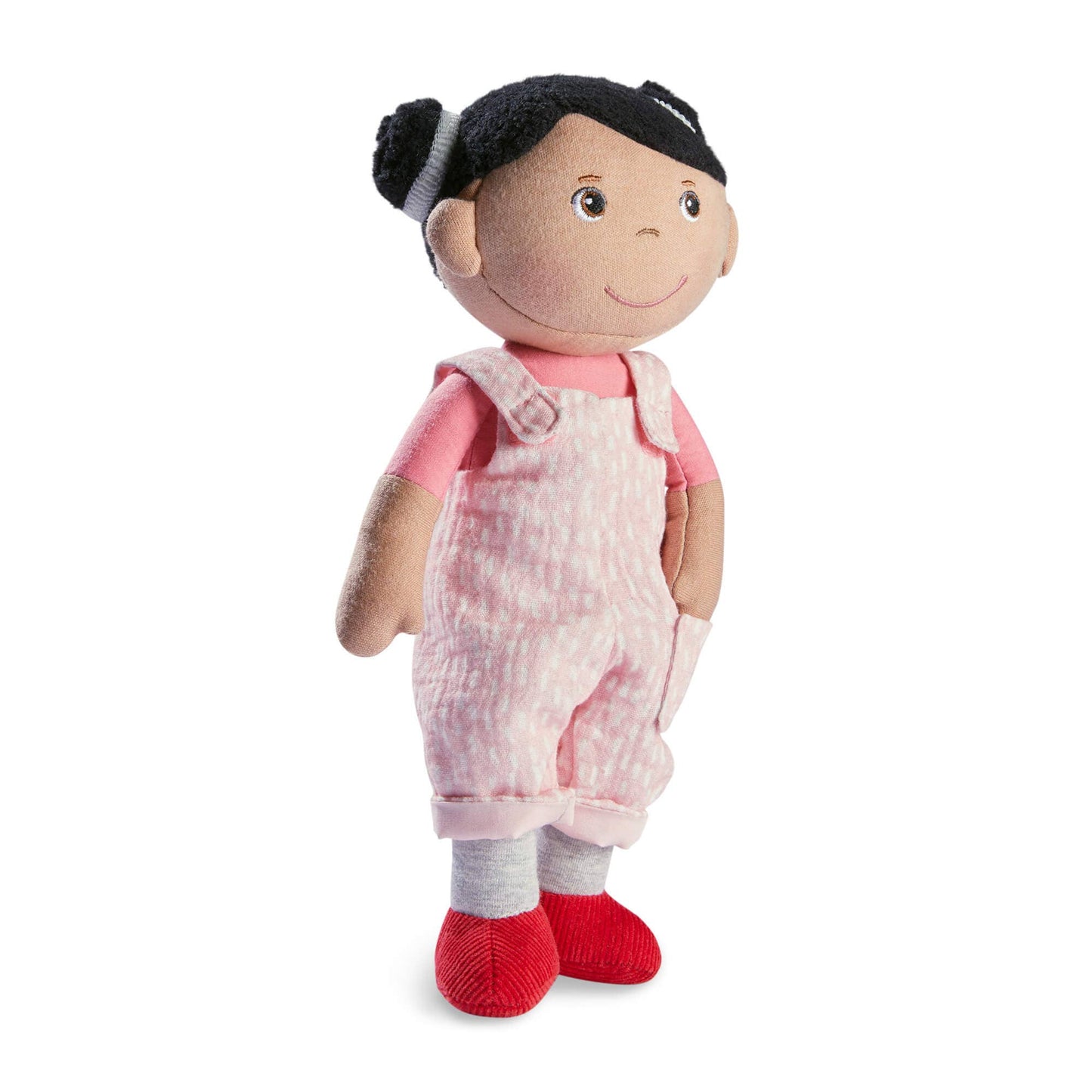 Plush doll with pink overalls and red shoes on a white background